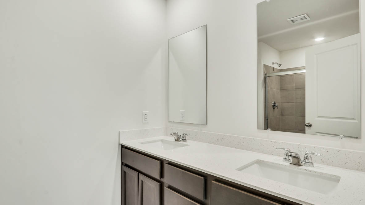 Primary Bathroom with dual sinks and walk in shower