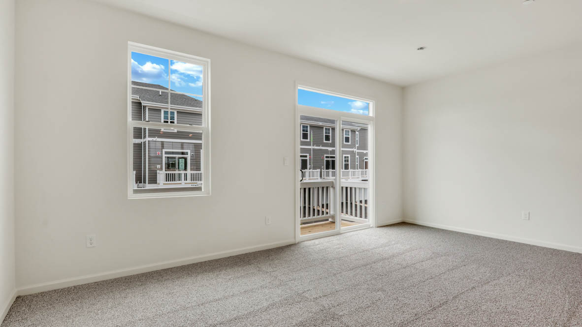 Living room in this new construction home features natural light, with fresh open concept flow to the kitchen, dining areas