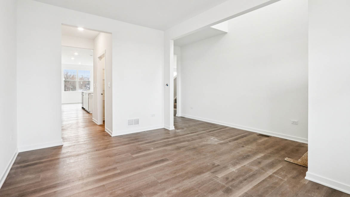 large flex room with small hallway leading through butlers pantry