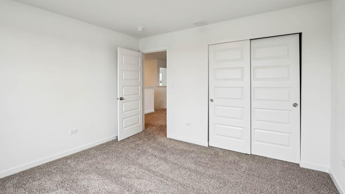 bedroom with carpet and closet