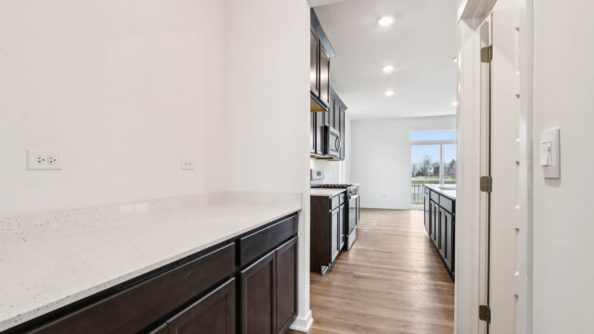hallway to kitchen with lower cabinets