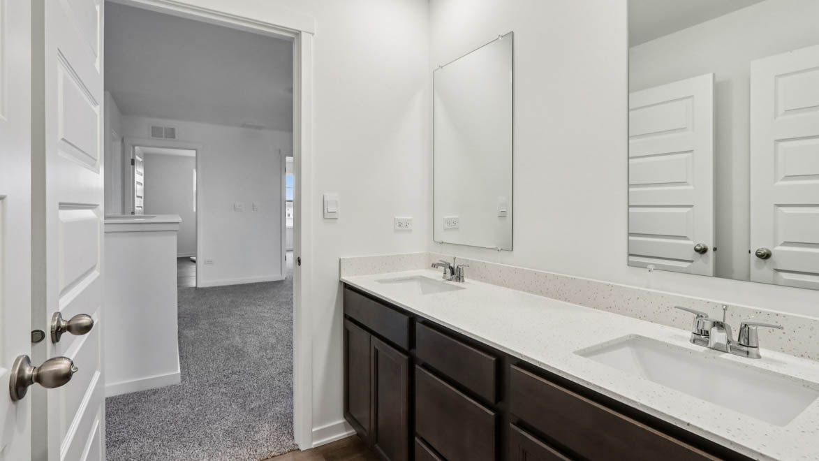 secondary bathroom with dual sinks