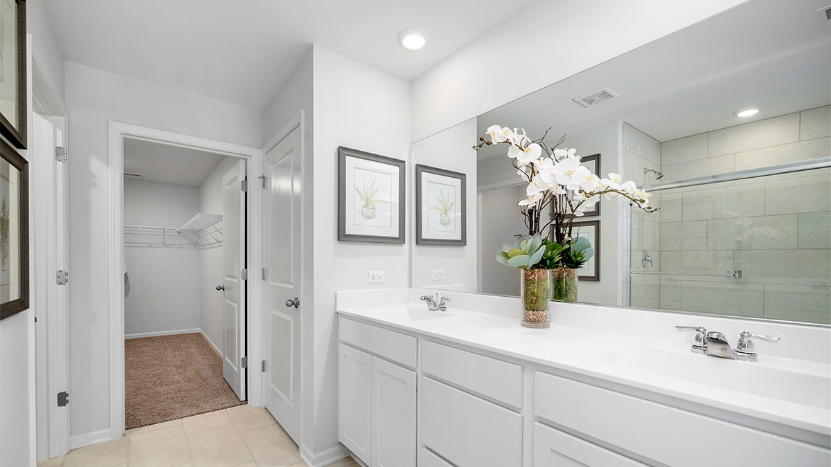 Primary bathroom with dual sinks and walk in shower
