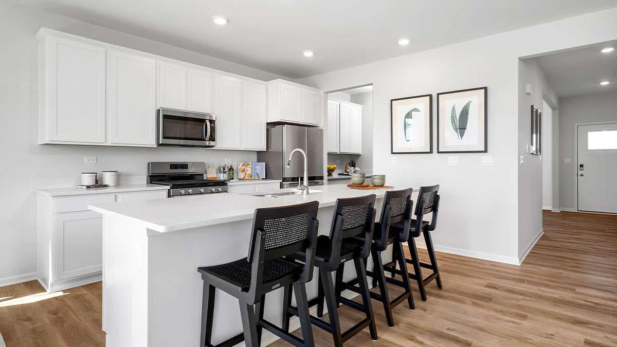 Kitchen with white cabinets and white quartz countertops