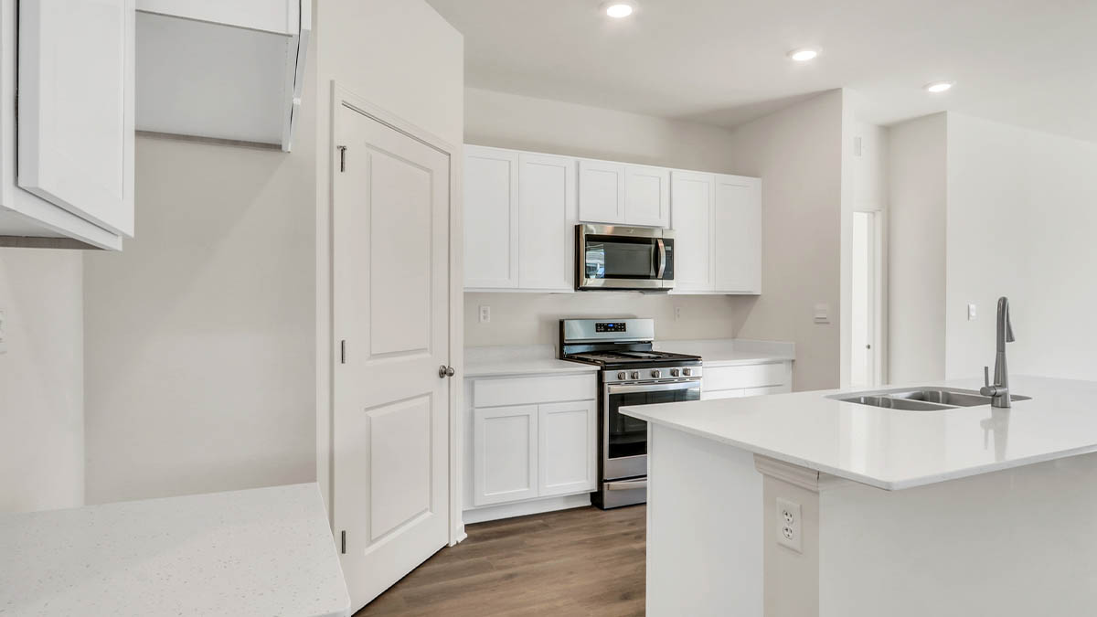 Kitchen with white cabinets and white quartz countertops