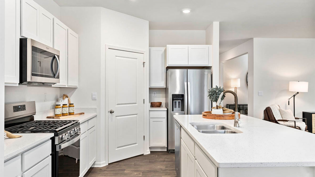 Kitchen with white cabinets and large island