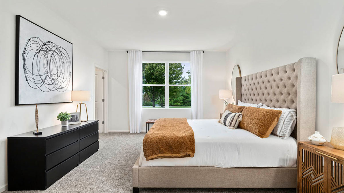 primary bedroom with carpet and window