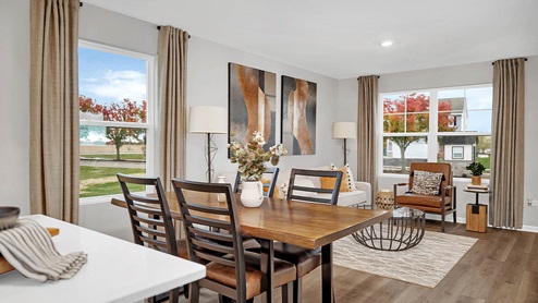 open concept dining and living room area with luxury vinyl planking