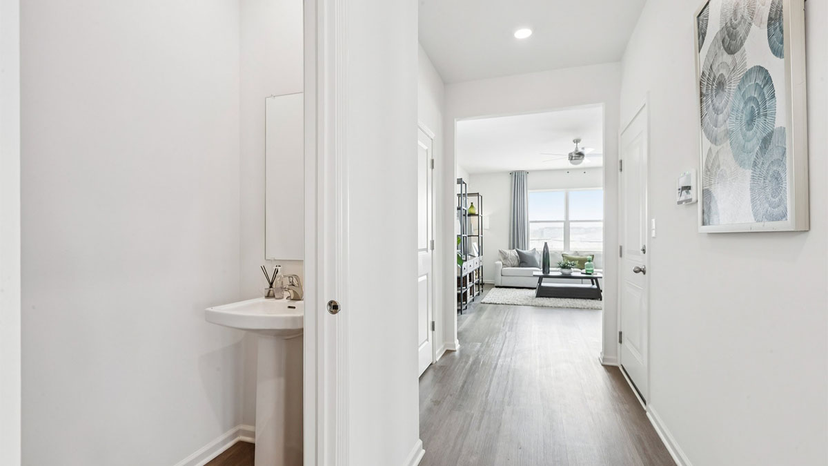 Entry hallway into great room with half bathroom