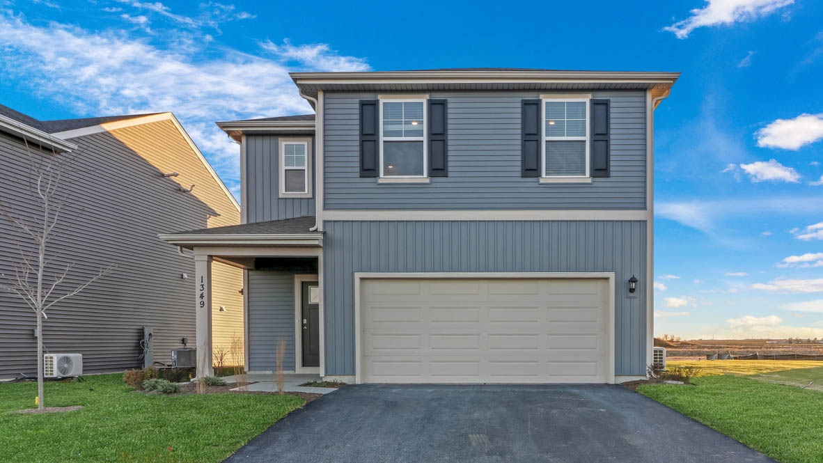 single family home with blue siding and two car garage