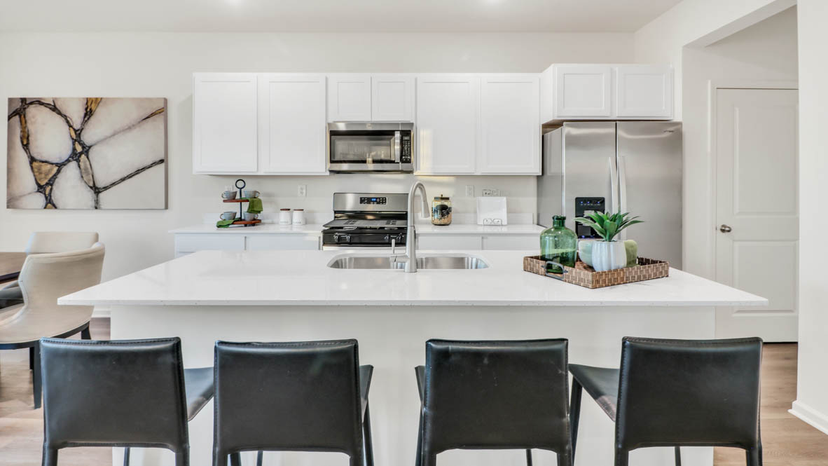 open concept kitchen with kitchen island and white cabinets