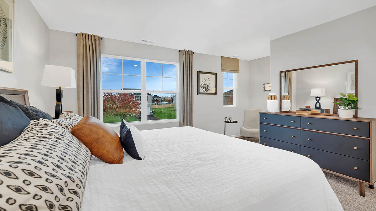 primary bedroom with carpet and large window