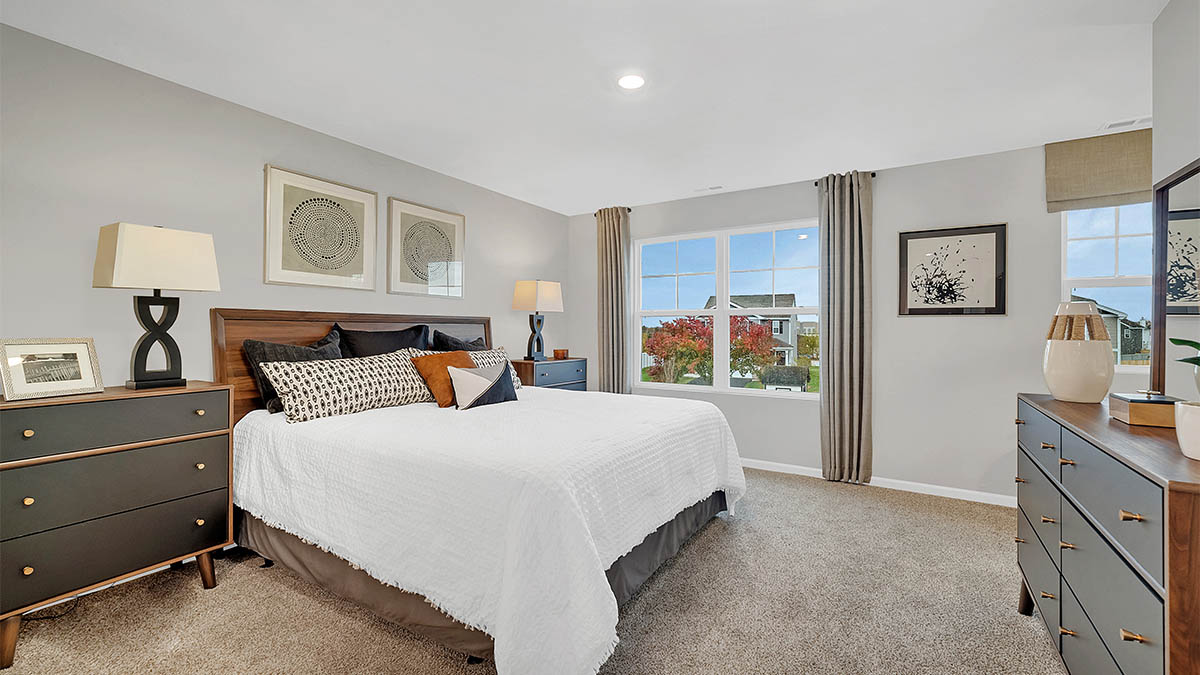 primary bedroom with carpet and large window