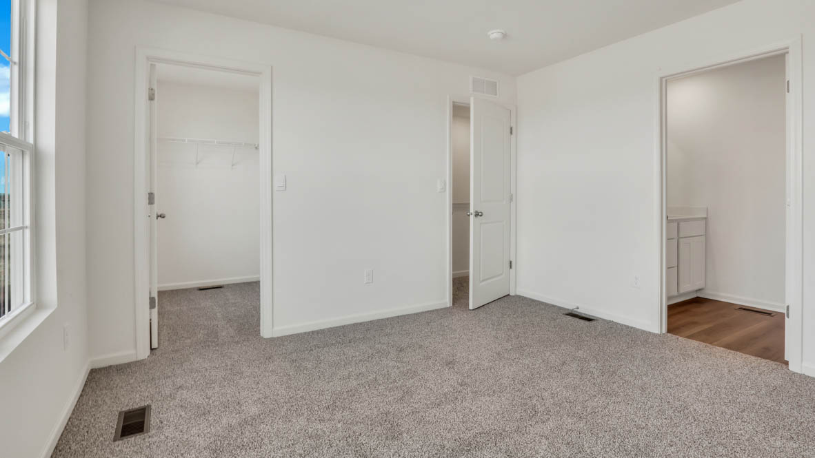 Primary bedroom with connecting en suite and walk in closet