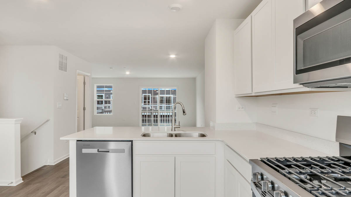 Kitchen with island and light cabinets and stainless steel appliances