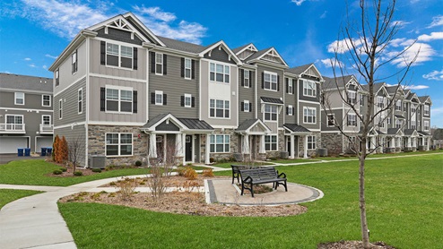 Modern 3-story townhome building with common area