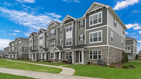 Modern 3-story townhome exterior with stone accents