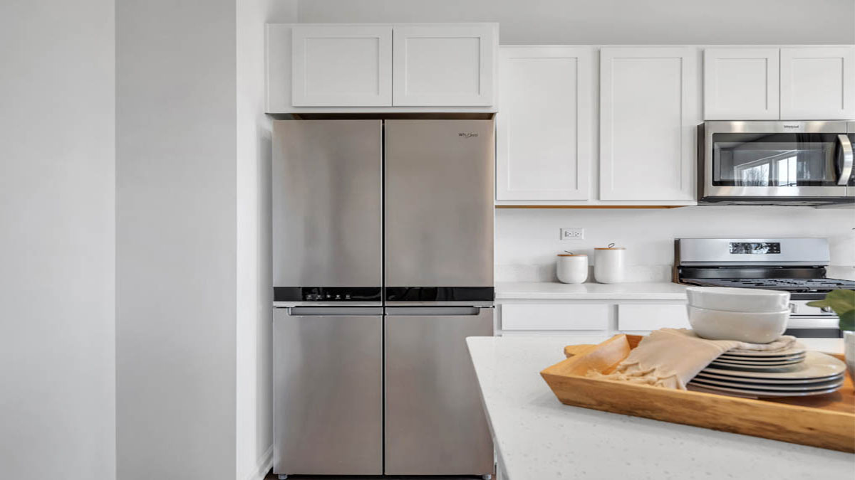 Kitchen with white cabinets and white quartz countertops