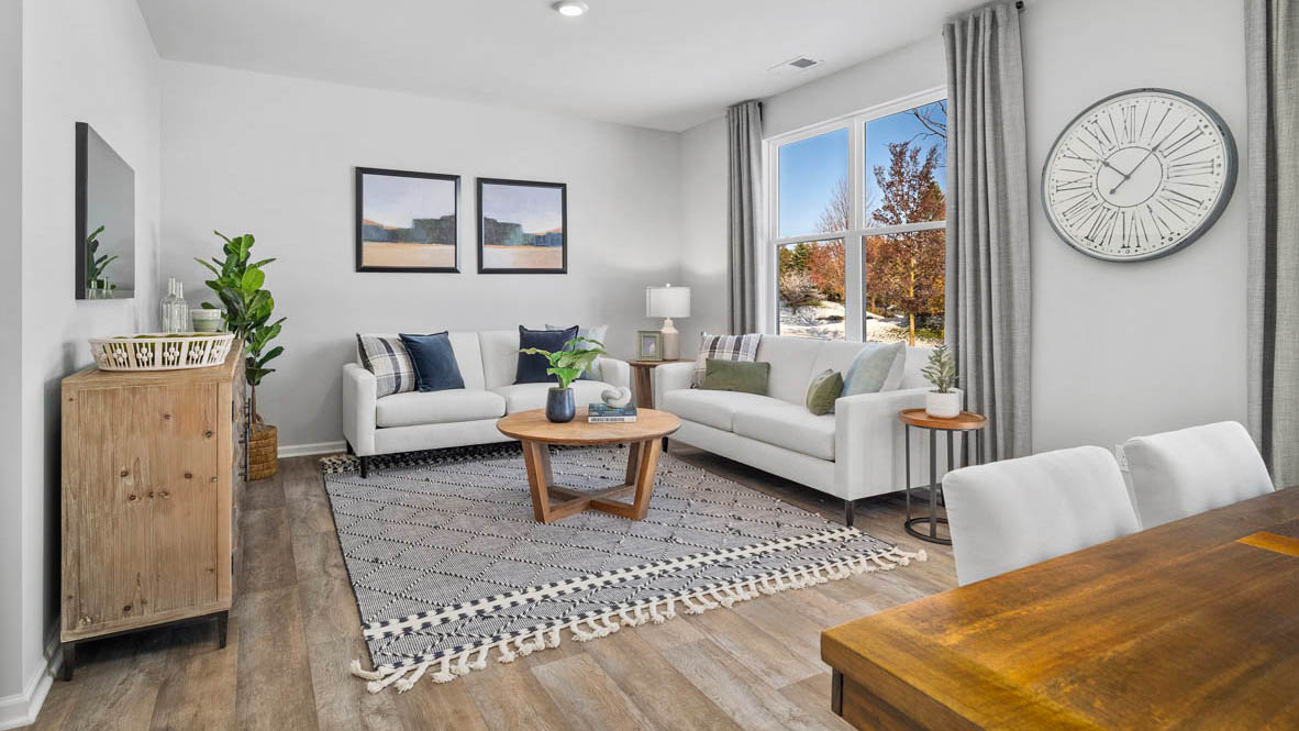 Living room with a large window for natural lighting.