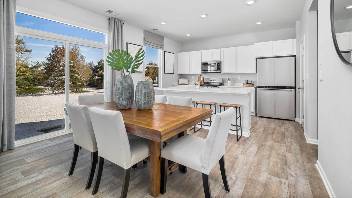 Dining area with a door for access to backyard.
