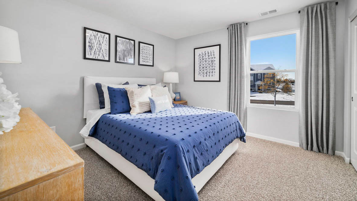 Bedroom with a single window and carpeted floors.