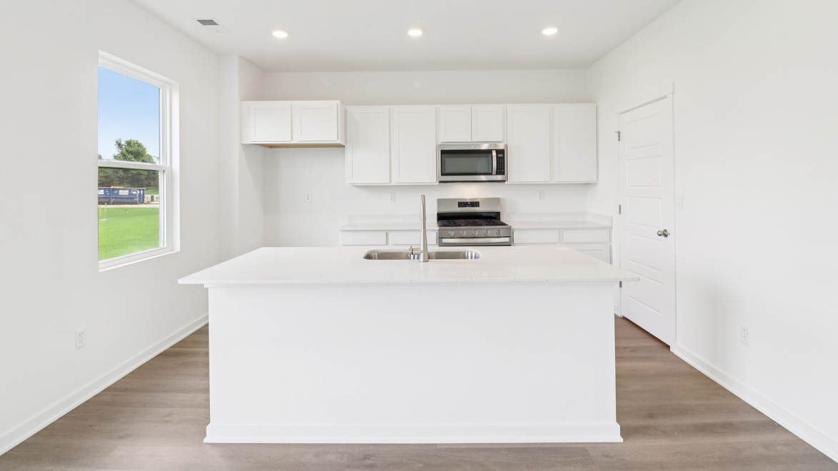 Kitchen with large island with sink and dishwasher
