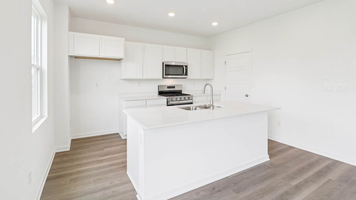 Kitchen with lower and upper cabinets along back wall