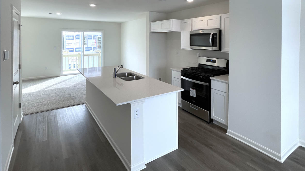 kitchen with white cabinetry, large island, and stainless steel appliances
