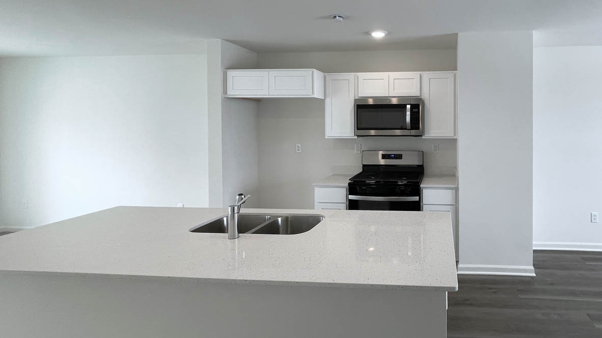 kitchen with white cabinetry, large island, and stainless steel appliances