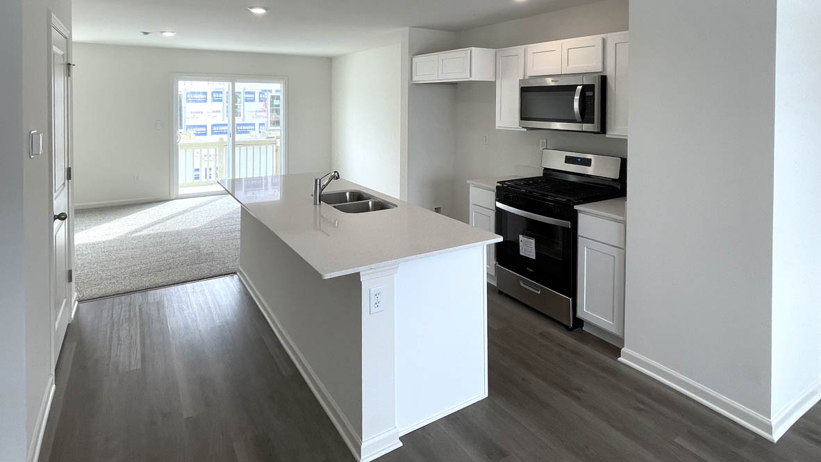 kitchen with white cabinetry, large island, and stainless steel appliances