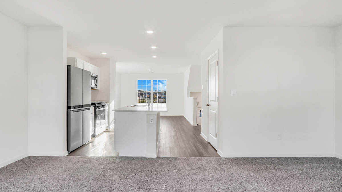 kitchen with white cabinetry, large island, and stainless steel appliances