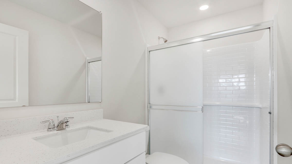 bathroom with a vanity sink, toilet and shower
