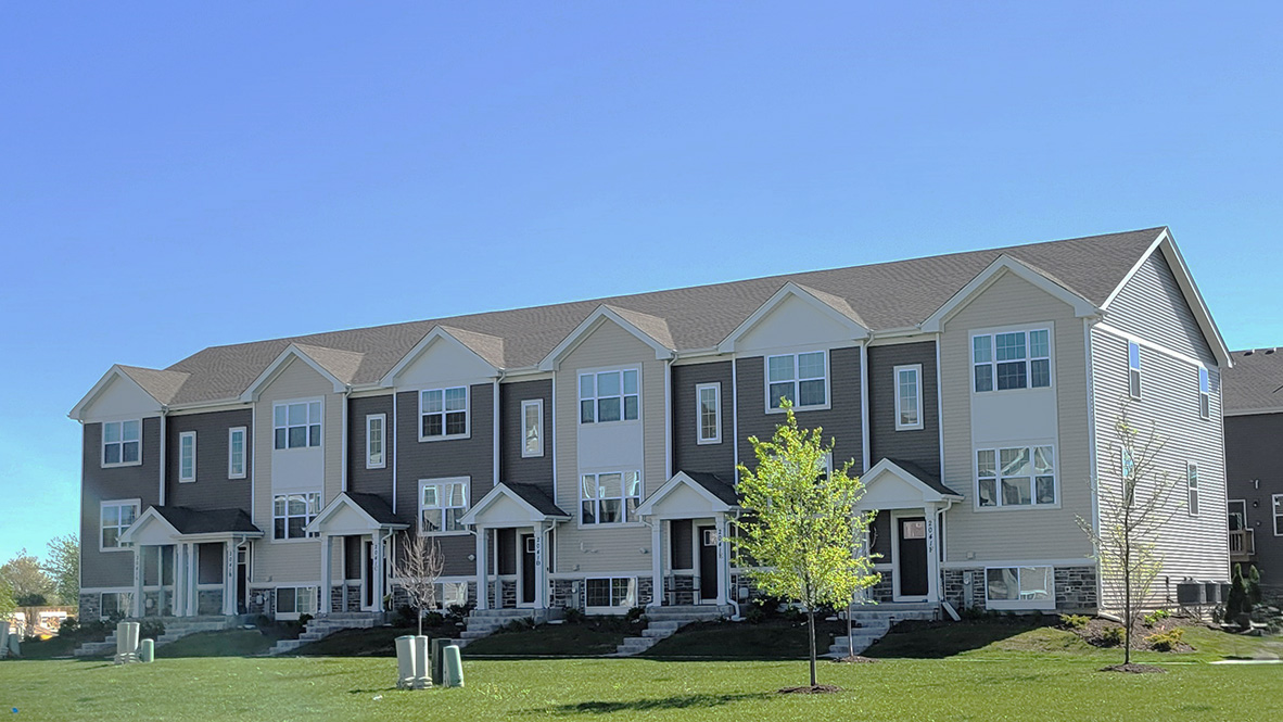 tri level townhome with stone and vinyl siding