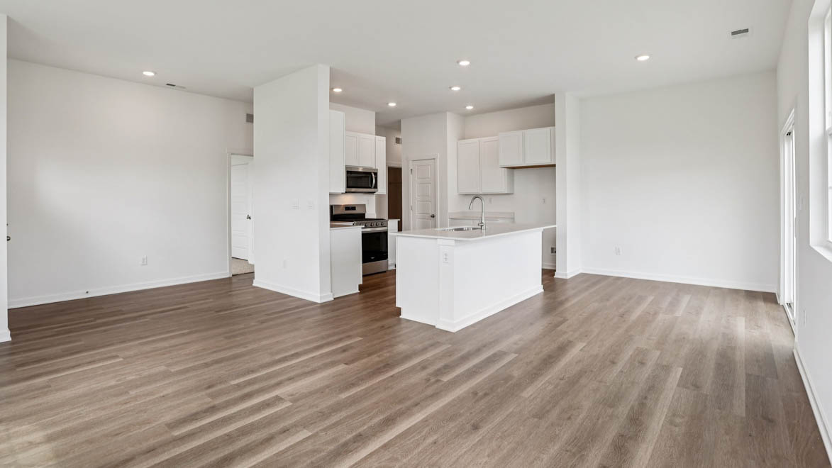 Functional kitchen island adds a sink, multi-prep zones, cabintes and a pantry, new appliance suite, and outside access