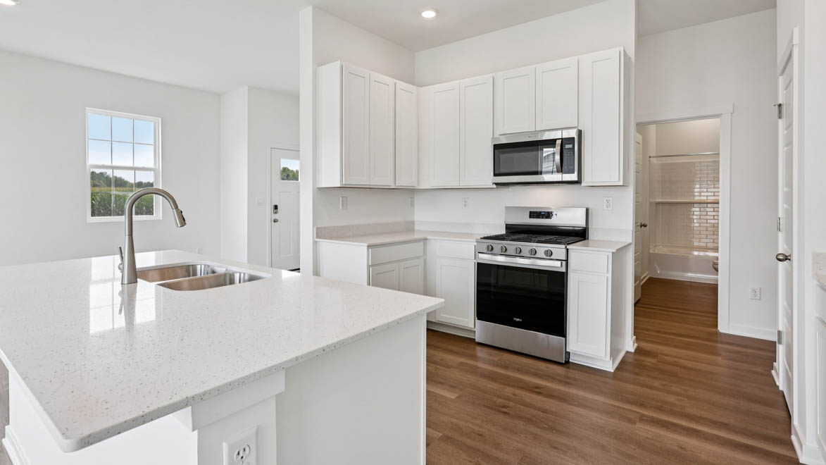 Central kitchen island adds a sink, seating, designed to anchor the home, pantry, prep zones, perfect for entertaining, everyday life
