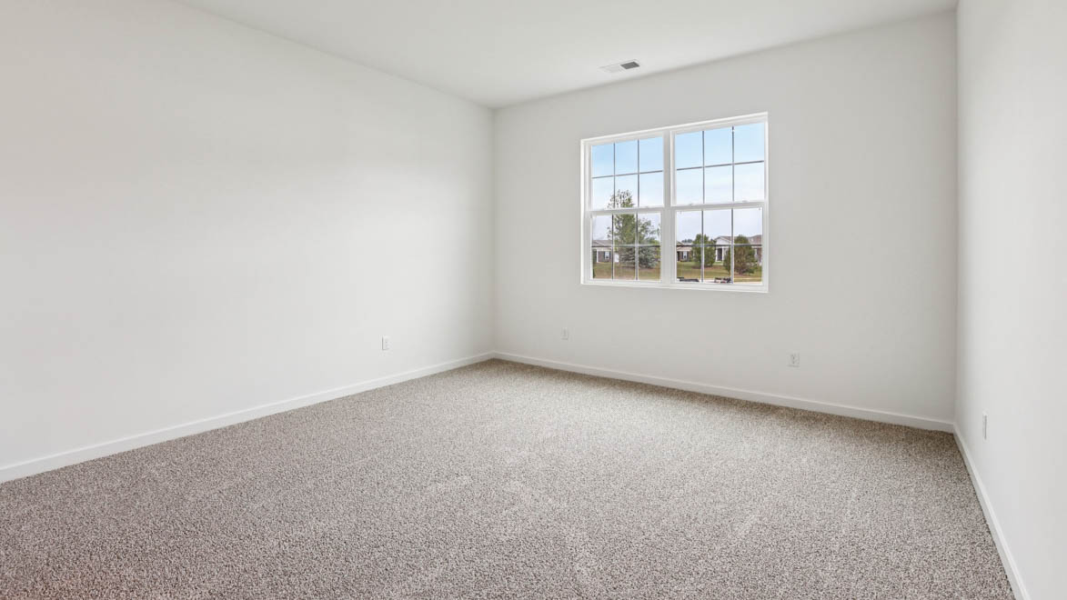 Primary bedroom features ample space, double windows, soft carpet, a stylish walk-in closet, and a private ensuite bath