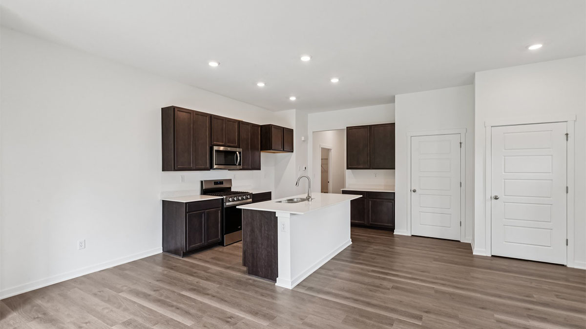 Central kitchen island adds a sink, seating, designed to anchor the home, pantry, prep zones, perfect for entertaining, everyday life