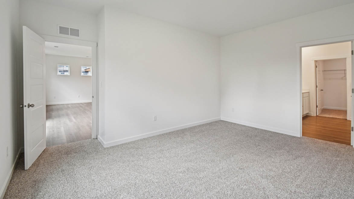 Primary bedroom designed with privacy and space in mind, a flow into a spa-inspired ensuite, walk-in closet on main level