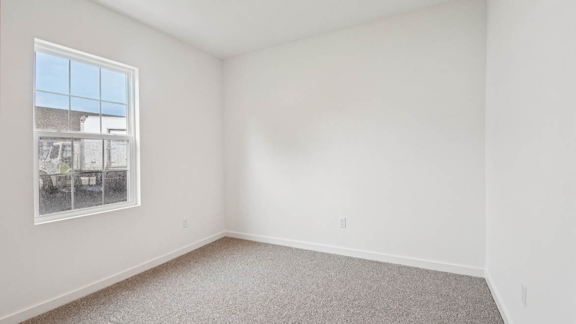 Second bedroom in Stonewater includes natural window light, full closet, connectivity to the residence