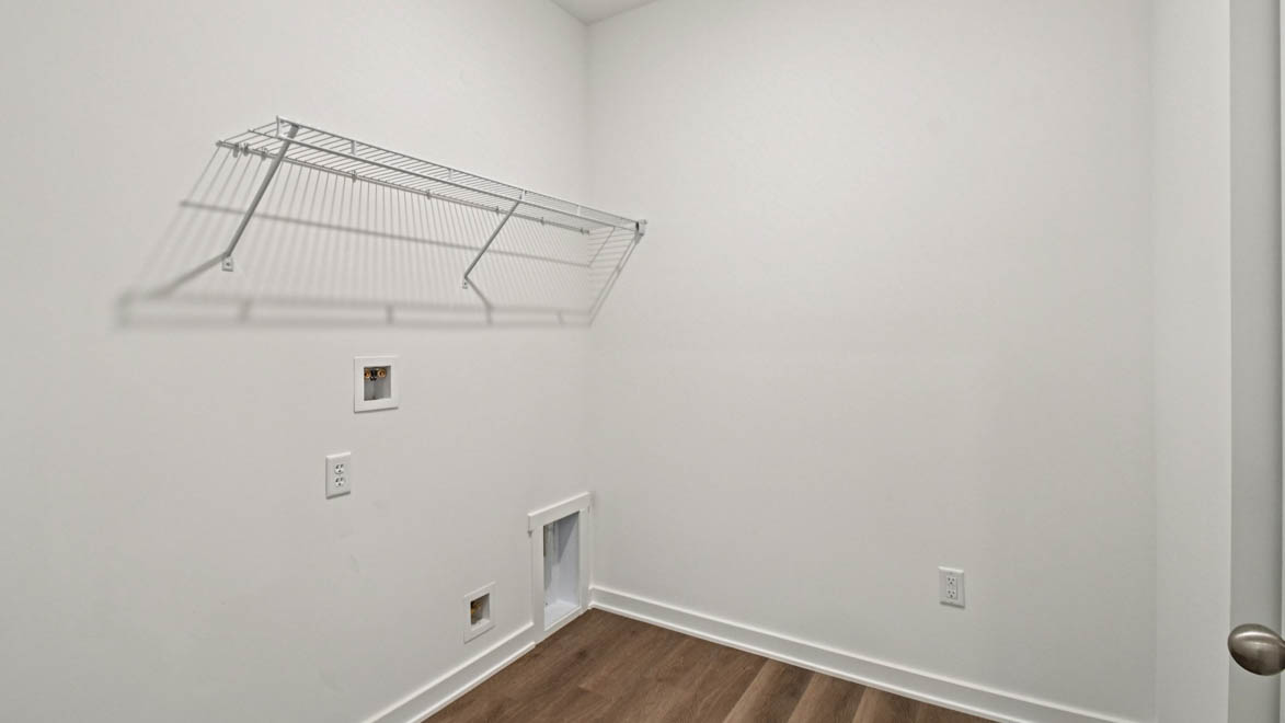 Laundry utility in Stonewater's new home by D.R. Horton featuring new washer, dryer included, overhead storage options
