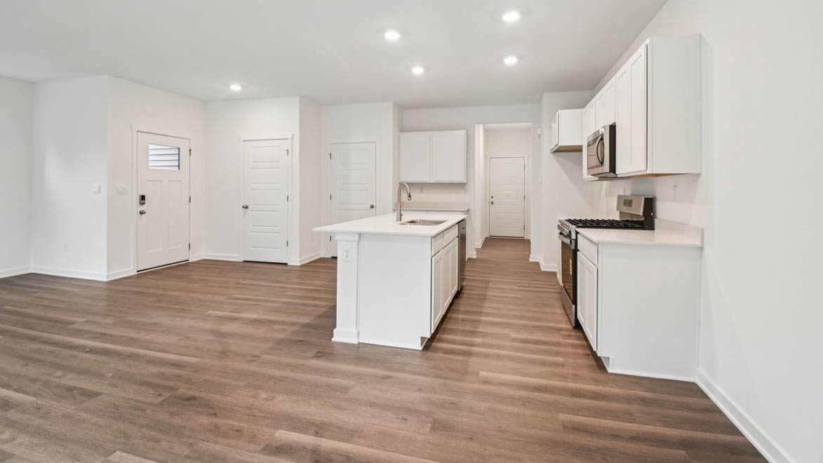 View from dining room into kitchen with island, pantry, new appliances and cabinet options at Stonewater
