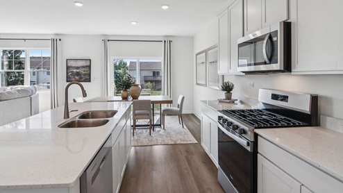 Kitchen with white cabinets, soft close drawers and crown molding