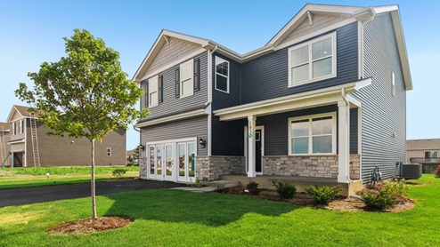 Henley model with grey vinyl siding stone accents and a front porch
