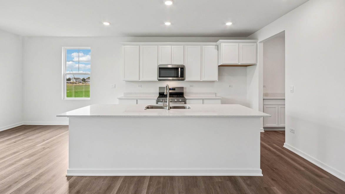 Kitchen with white cabinets and white quartz countertops