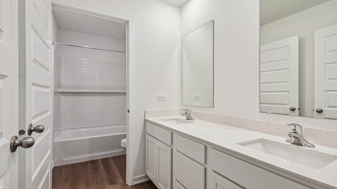 Secondary full bathroom with water closet and dual sinks