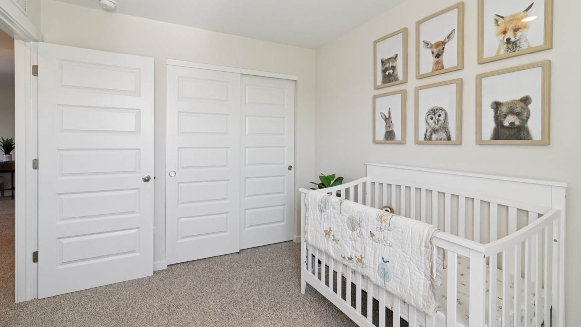 bedroom with beige carpet, white walls and a window