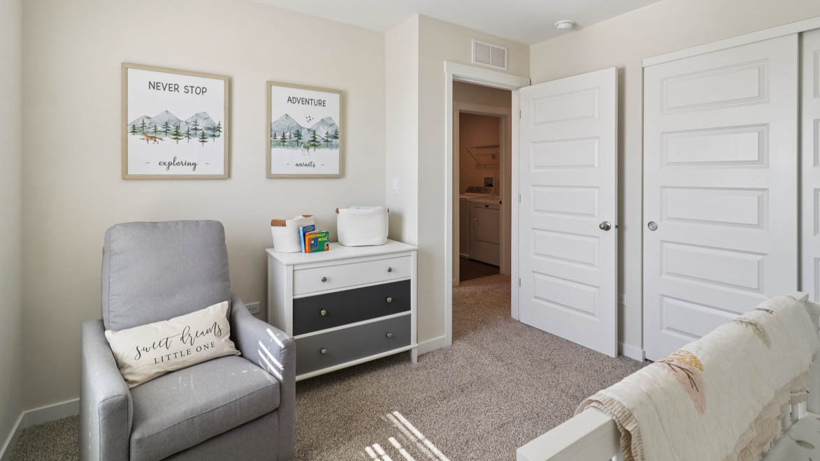 bedroom with beige carpet, white walls and a window