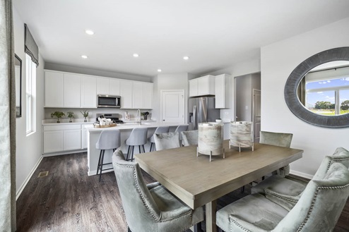 Open concept dining room with table in Ivanhoe Holcombe model