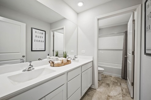 Bathroom with shower and double bowl vanities in Ivanhoe Holcombe model