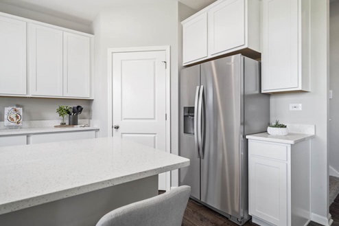 Ivanhoe Holcombe model's open concept kitchen with pantry and refrigerator